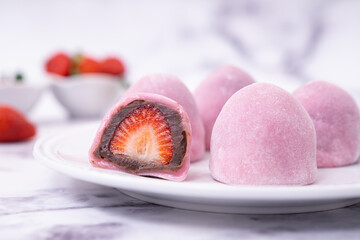 Japanese confectionery Ichigo Daifuku, small round glutinous rice dessert with fresh strawberry and...