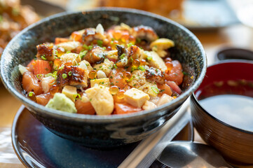 A set of sushi on a wooden table in a Japanese restaurant.Fresh salmon sliced for sushi menu.