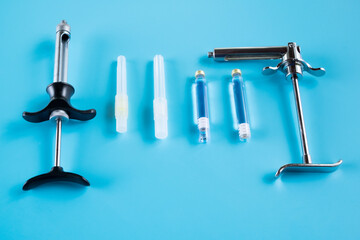 Dentistry medical tools syring on blue background.