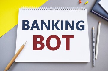 Handwriting text Banking Bot. Concept meaning application that runs automated banking tasks over the Internet BANKING BOT text written in Notebook.