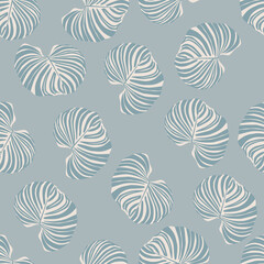 ABstract seamless random pattern with white and blue colored tropical leaves of monstera.