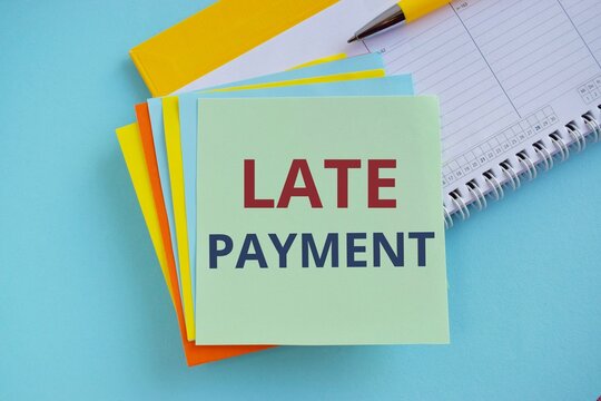 Late Payment Text Written On Sticker Note, Business Concept Of Payment Made To The Lender After The Due Date Has Passed. Blue Background