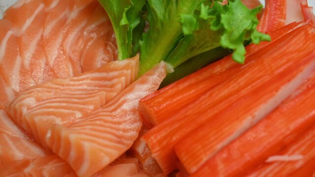 salad salmon sashimi and crab stick on plate, 4k rotating scene