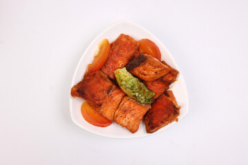 Pan friend salmon fish fillet in white triangular plate on white background