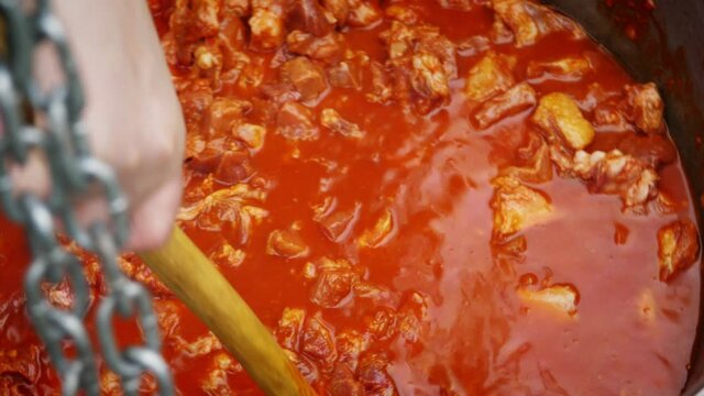 Bograch. Soup with paprika, meat, bean, vegetable, dumpling. Traditional Hungarian Goulash in cauldron. Meal cooked outdoors on an open fire. HD