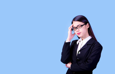 Businesswoman with a stern face on a blue background, studio portrait.