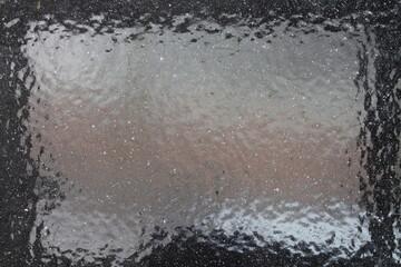 Close-up of frosted car windshield. Car covered with ice. Winter frozen front window car, ice glass freeze texture background.