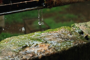 Heavy rain outdoors. Water droplets splashing from the bricks. isolated raindrops