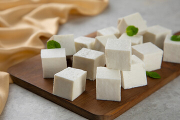 Diced Paneer or cottage cheese with green leaves. 	