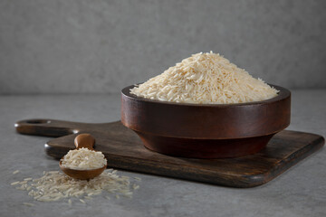 Uncooked Rice in a wooden bowl	