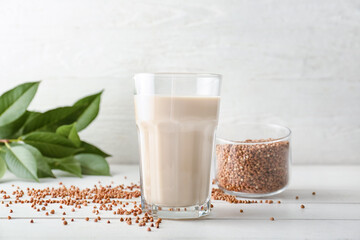 Glass of tasty buckwheat milk on table
