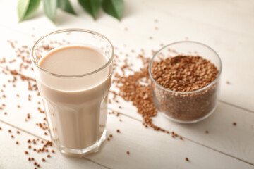 Glass of tasty buckwheat milk on table