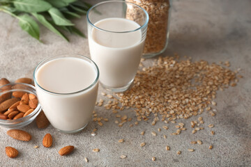 Glasses of tasty vegan milk on table