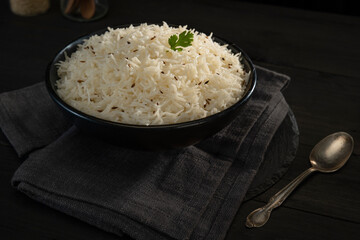 Steamed rice with Cumin  in a black bowl	