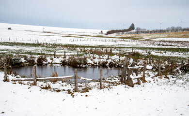 winter landscape with pond and fence