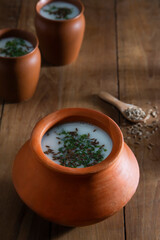 Salted Butter Milk in earthen pots  on wooden table	