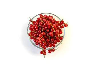 Isolated on white background red currant berries in a transparent plate