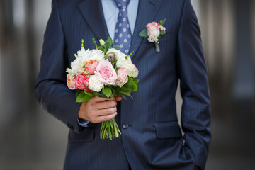 Wedding bouquet in Groom's hands, Wedding day