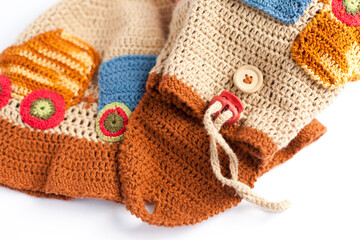 Handmade knitted backpack (backbag) for a child with an application of the train