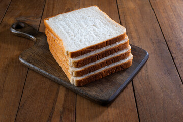 Stack Of white  Bread slices  on a wooden table	