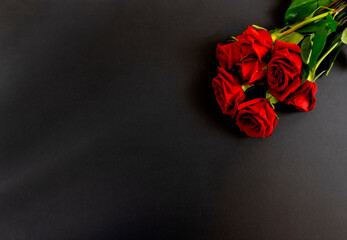 Red roses on a black background, postcard, banner, Flat Lai on the funeral