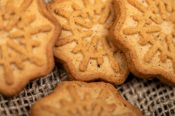 Delicious homemade cookies on a wooden table on a homespun fabric with a rough texture. Close-up selective focus.