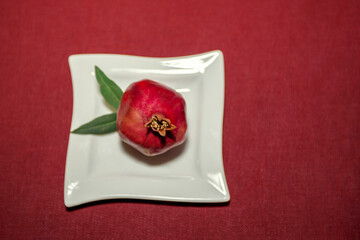 Ripe pomegranate fruits close up. In the background there is a blurred background.