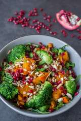 healthy tasty Broccoli salad with pomegranate on a table