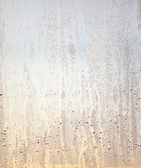 Drops of water on glass in the rays of the dawn of the sun.