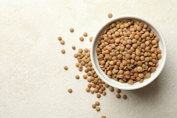 Bowl with legumes on white textured background