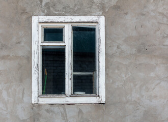Old wooden window in a concrete wall.