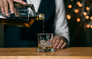 Barman pouring whiskey whiskey glass beautiful night