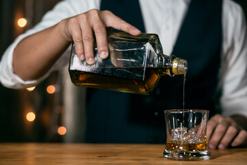 Barman pouring whiskey whiskey glass beautiful night