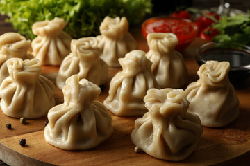 Concept of tasty lunch with board of khinkali, close up