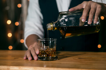 Barman pouring whiskey whiskey glass beautiful night