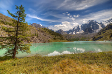 Fototapeta na wymiar A beautiful lake in a mountain valley. Mountains, sky with clouds. Natural background.