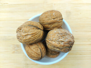 walnuts in a bowl,walnuts on a wooden table