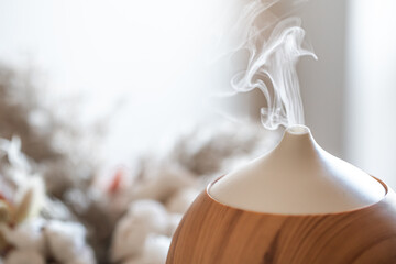 Modern oil aroma diffuser close up on a blurred background.