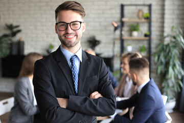 Fototapeta premium Businessman with colleagues in the background in office.