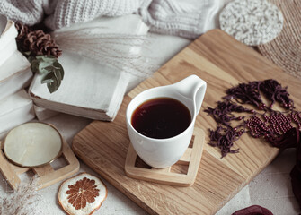 A beautiful cup with a drink on a wooden stand with decor details top view.