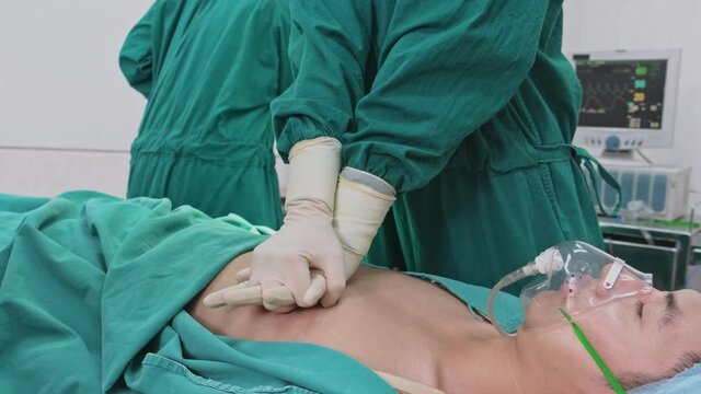 Group of Asian professional surgeons and nurses team making CPR.	