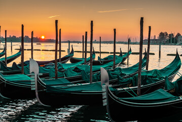 Sunrise over an empty Venice, gondolas stopped without tourists. © cineuno