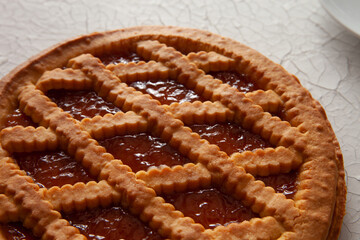 detail of apricot tart on a light background