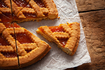 detail of sliced apricot tart over wooden table