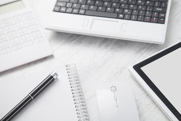 White laptop on the white business desk. Business workplace
