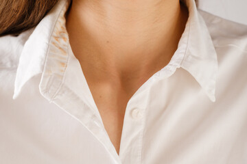 dirty stain from the foundation on the collar of the shirt