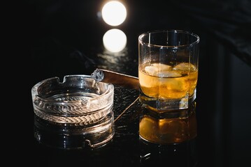 Whiskey drink with smoking cigar