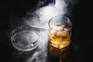 Whiskey drink with smoking cigar