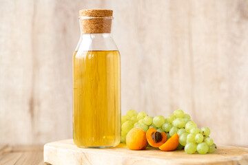 Homemade white wine or apple cider vinegar in a tall bottle with a wooden stopper.