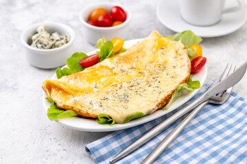 Fried eggs with cheese, cherry tomatoes and fresh lettuce.